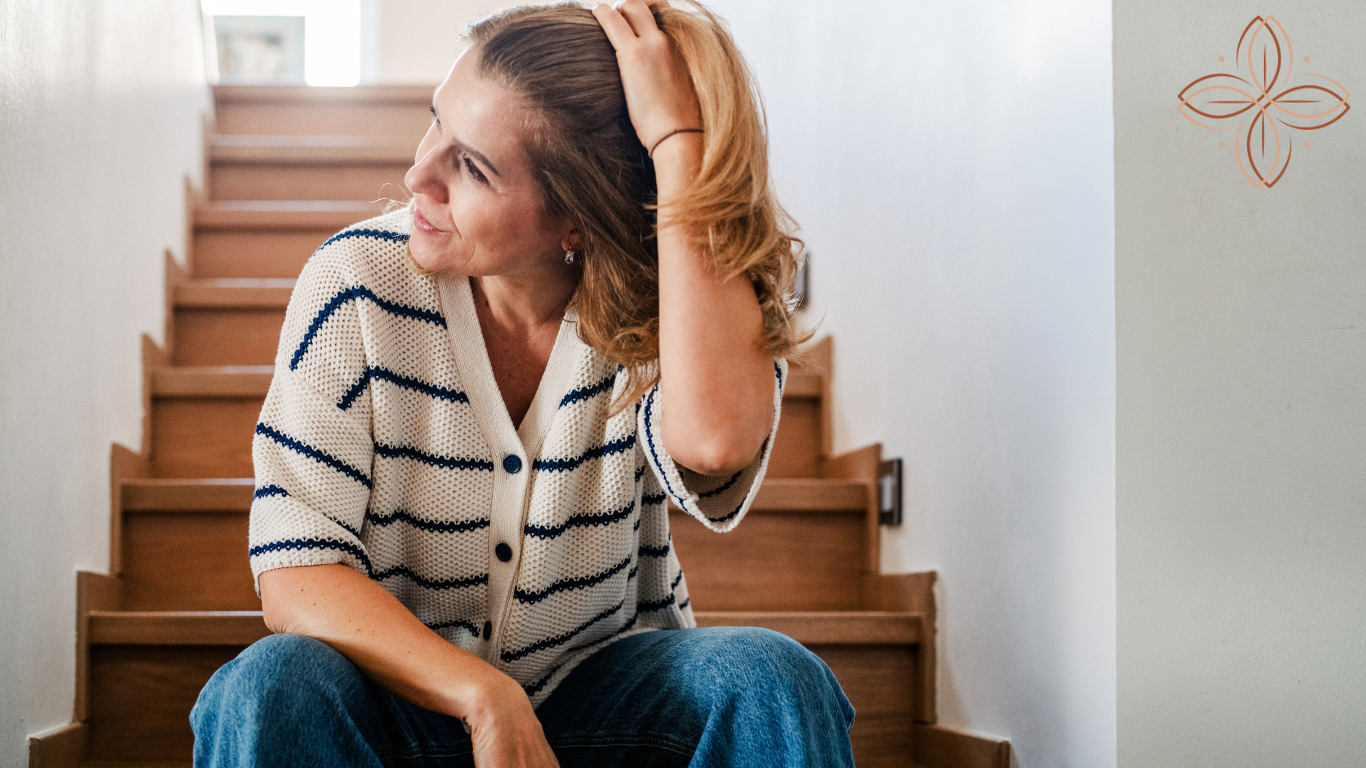 Woman holding her head in overwhelm, illustrating perimenopause anxiety and mood changes
